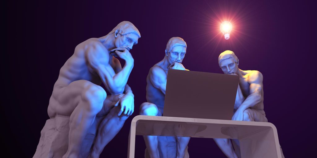 Arranged statues looking at a computer screen